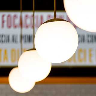 Chandeliers and illuminated signs inside an ALT store