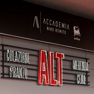 Side view on outdoor sign of an ALT store, with Enilive and Niko Romito Academy logos